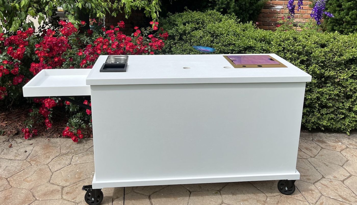 Front of a white coffee and espresso cart with a classic white wood top, stainless wells and a gold drop-in sink