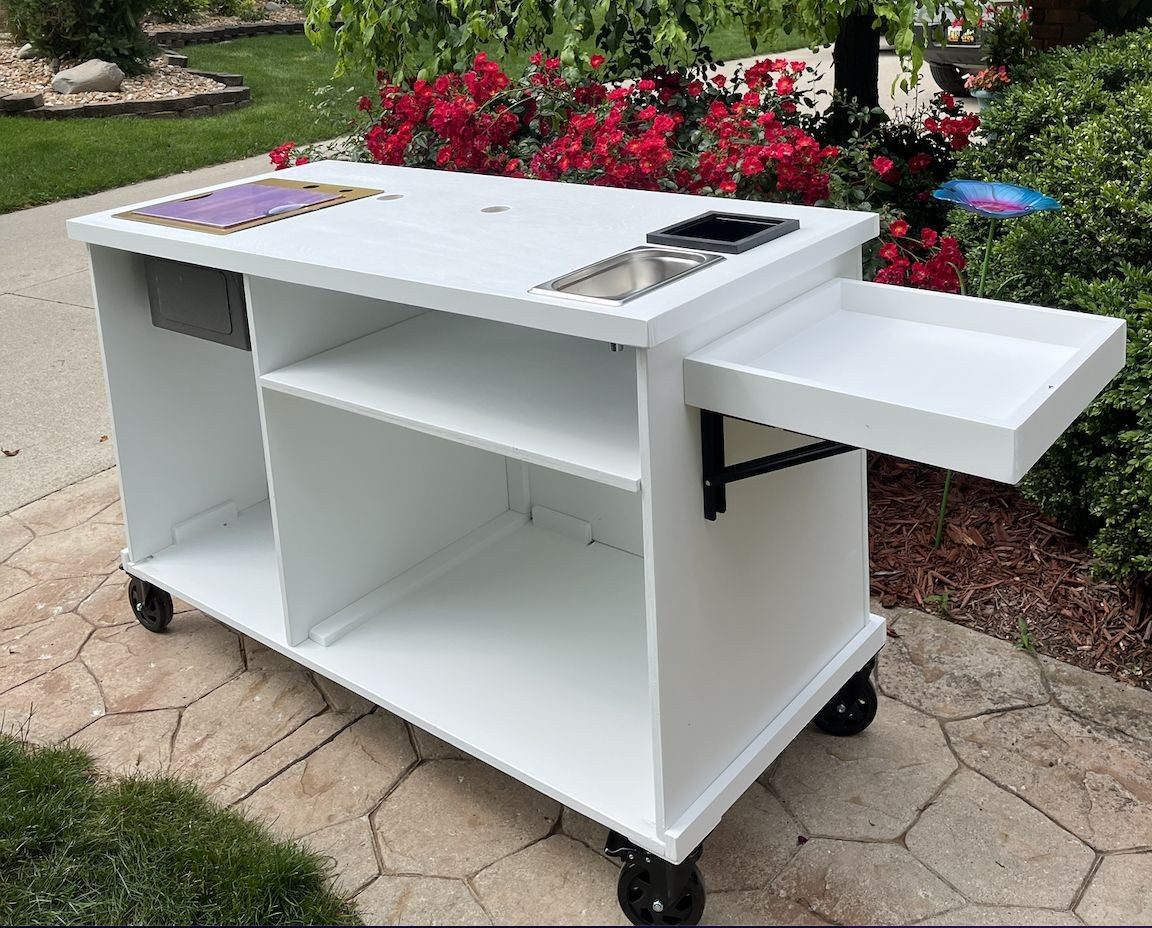 Back of the same cart with open shelving and a fold-out side tray