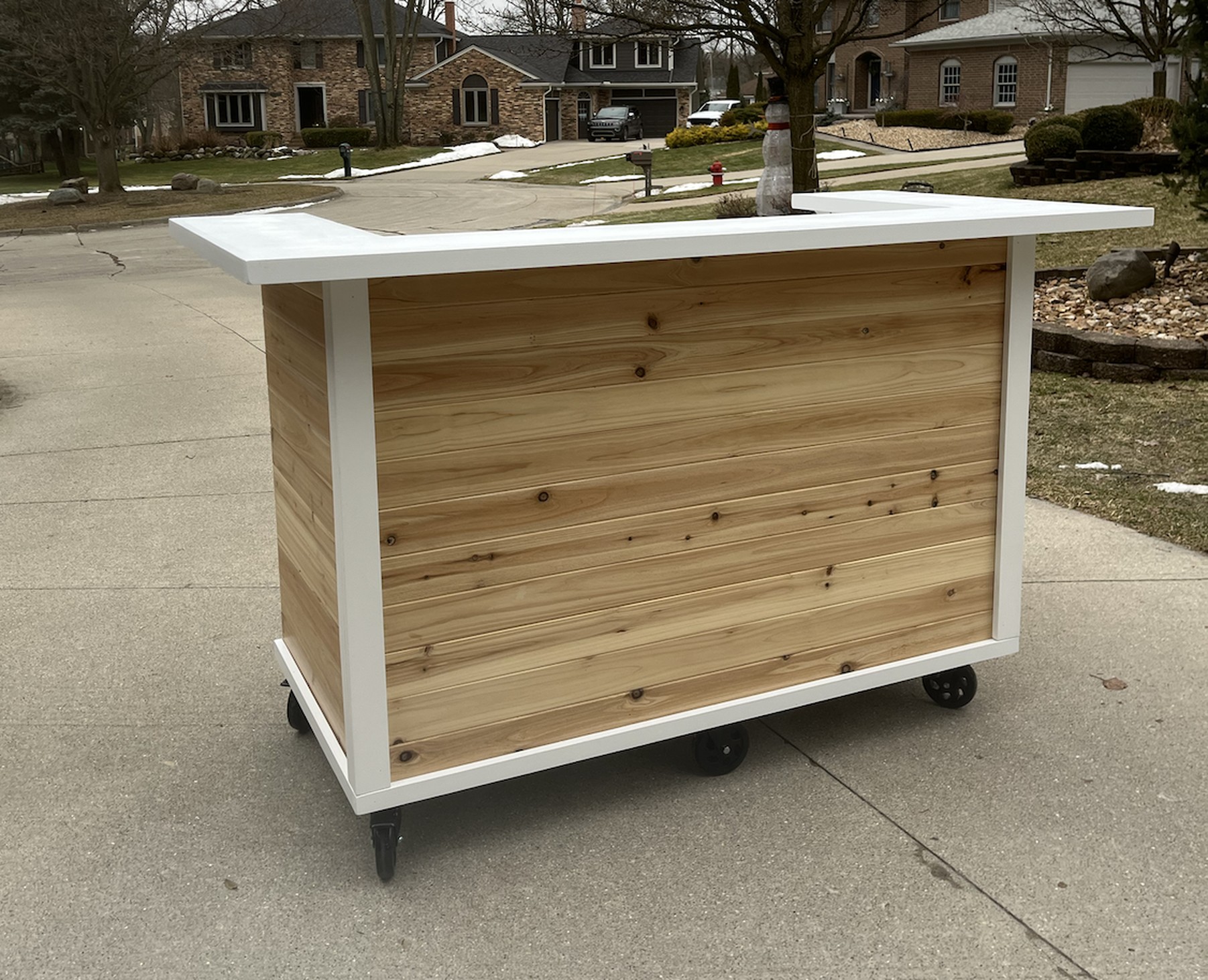 Front of the two-level bar cart: a white frame with a cedar-slat front panel and a raised U-shaped top