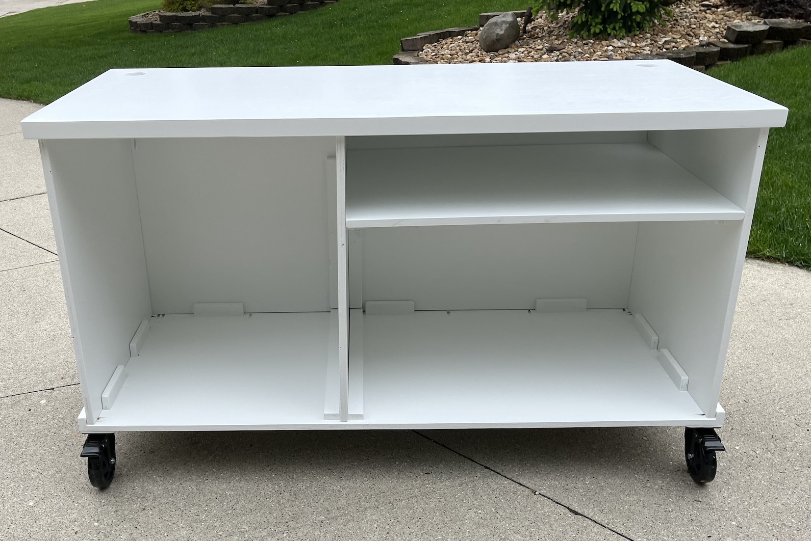 Open back of the white trim cart with interior storage and a divider shelf