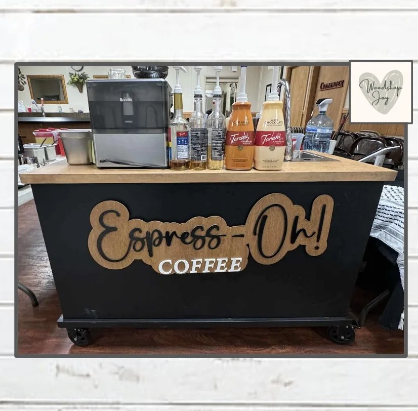 Espress-Oh! Coffee: a black mobile coffee cart with espresso machine, syrups and a drop-in sink